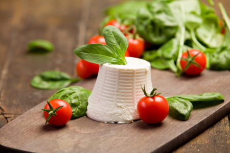 with basil leaves and cherry tomatoes